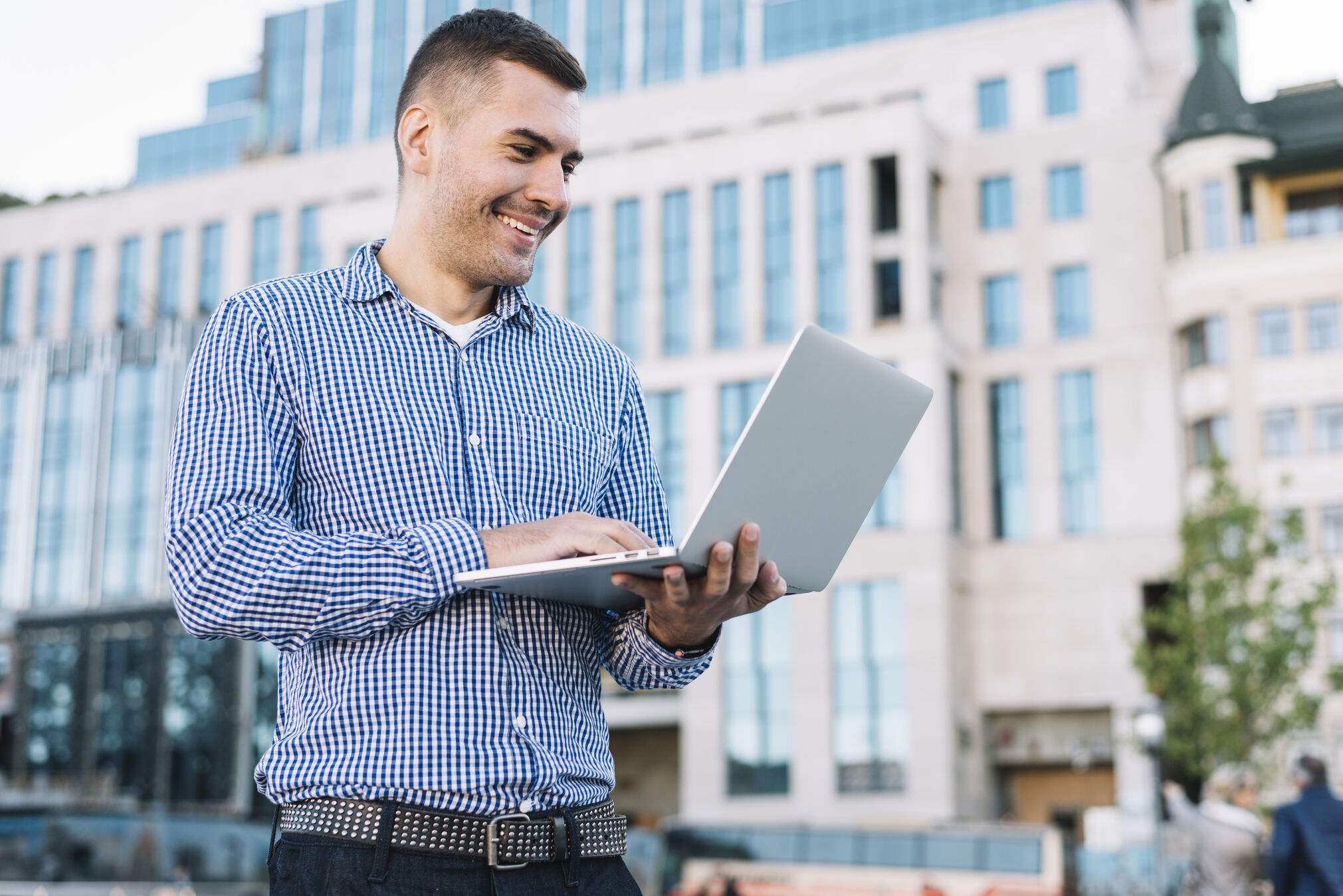 Real estate agent using laptop to test the best real estate apps for marketing and CRM