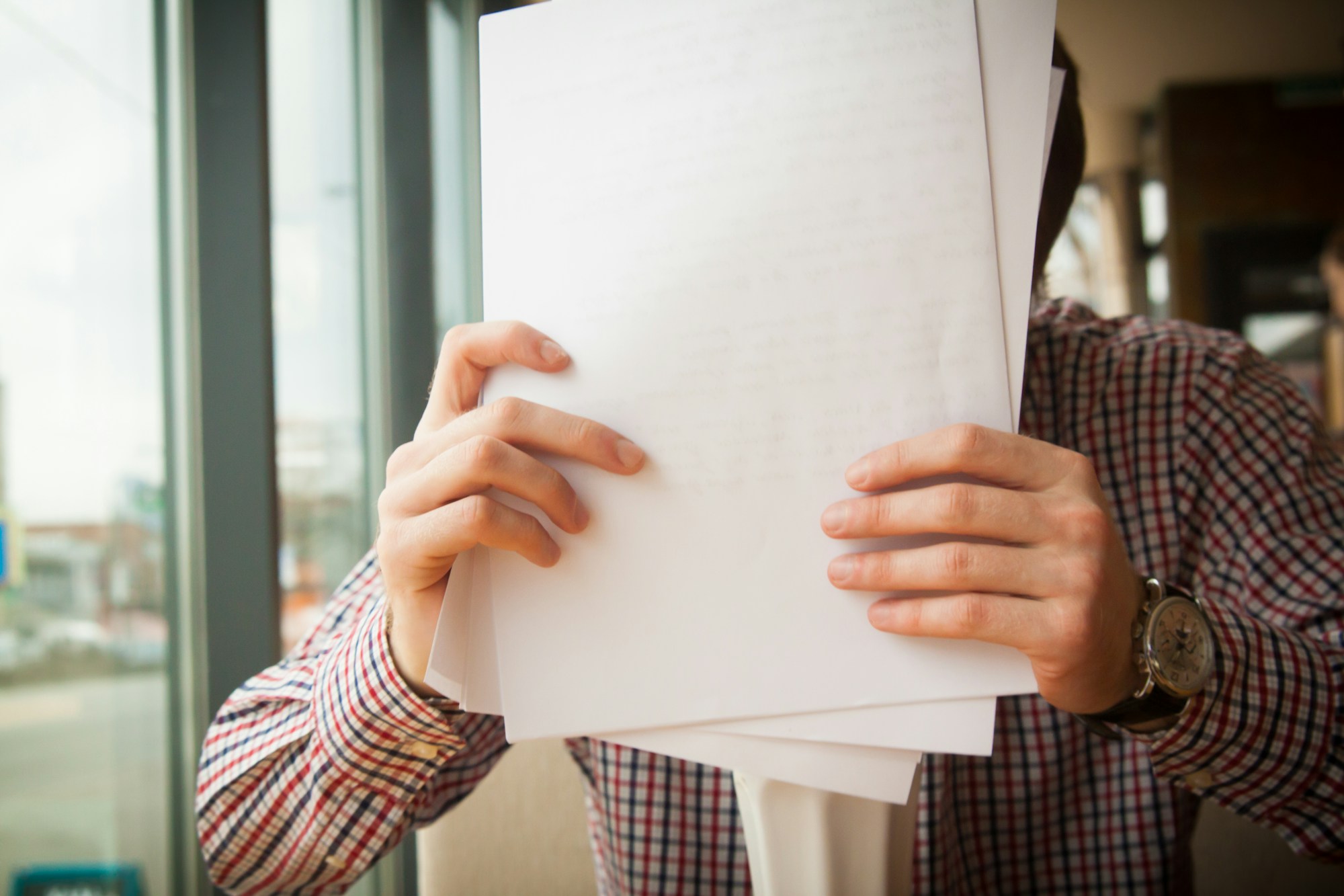 A homebuyer reviewing contract paperwork with an agent who is handling dual agency in real estate for both parties.