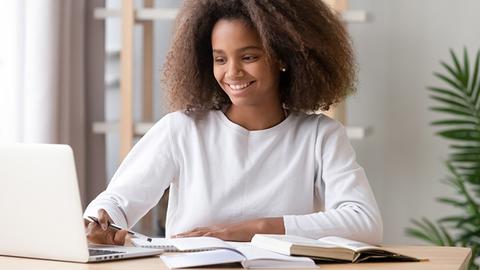 Woman studying with laptop.