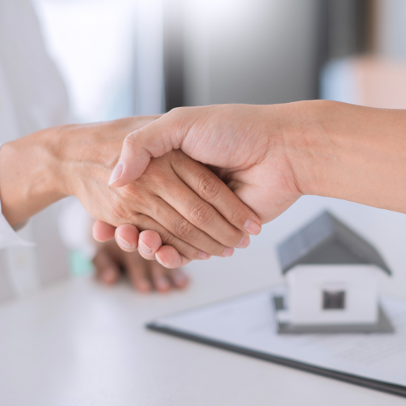real estate agent handshake with client