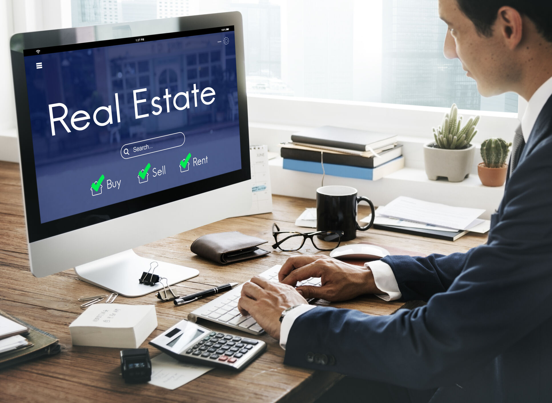 Realtor searching for profitable niches for real estate agents on a laptop